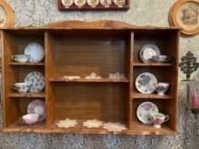Wall display cabinet with cups and saucers