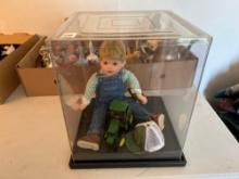 Boy doll locked in John Deere display.