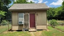 12ft wide x16ft long x 15ft tall to top of gable. Storage/work shed.