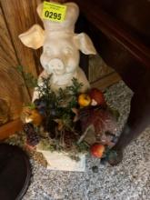 Statue of a pig and a circle grow in Grace decor