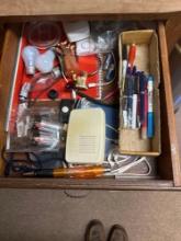 drawer in kitchen full of stuff like ink Batteries, lightbulbs, and more