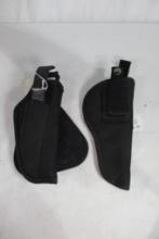 Two black nylon holsters. One is a paddle and on is for a 1911. Look new with paperwork. Right