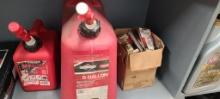 Box of small engine spark plugs and 2 gas cans