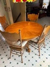 round Oak clawfoot table with four chairs