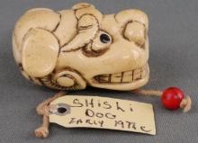 SHISHI DOG WALRUS TUSK NETSUKE EARLY 19TH CENTURY