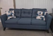 Blue standard sofa with two pillows