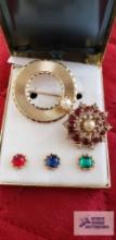 Gold colored circle pin with interchangeable gemstones marked Beau Jewels and other gemstone pin