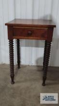 Antique rustic stand with turned legs. 27 in. tall by 18 in. long by 16 in. wide