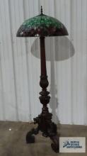 Antique carved floor lamp with antique leaded glass shade. Lamp is 68-1/2 in. tall. Lamp shade is