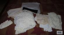 lot of handmade linens and doilies