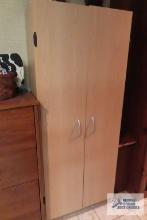 wooden two door cabinet in basement