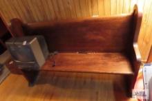 wooden church pew in basement, approximately 6 ft long