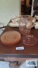 Pink depression glass pitcher, candy dish and plates