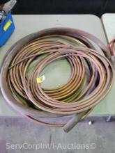 Lot on Table of Various Rolls of Copper Tubing