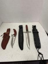 Three knives or daggers in sheaths