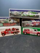 5 Hess toy trucks and cars. New in box