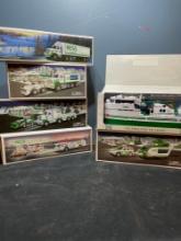 6 Hess toy trucks, cars, boat and helicopters. New in box